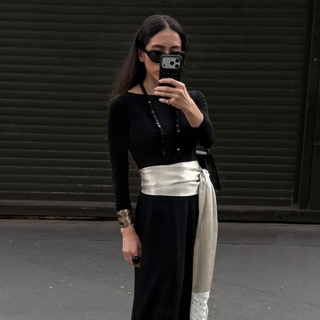 Alexis Badiyi wearing a cummerbund and a black top